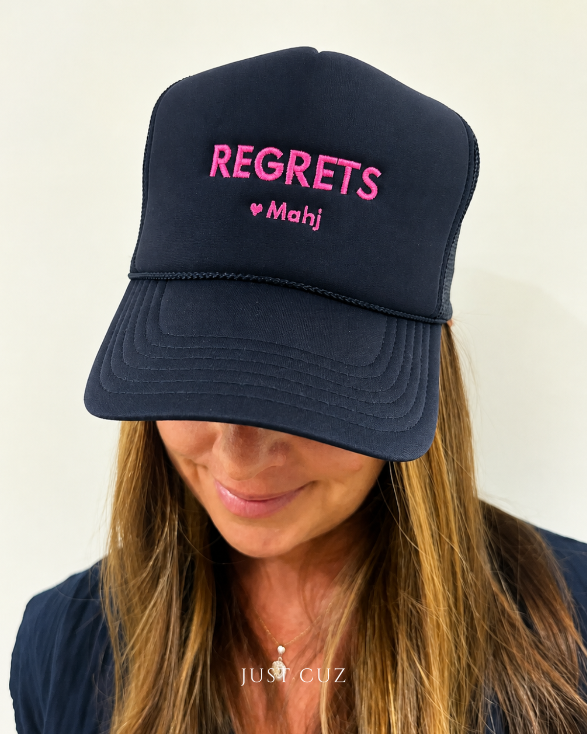 Photo of women wearing a Regrets Mahj Embroidered Navy Pink Hat